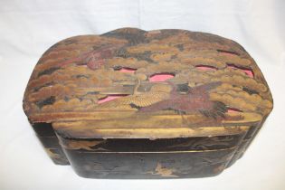 A Japanese lacquered shaped-rectangular table box decorated with two cranes and numerous foliage