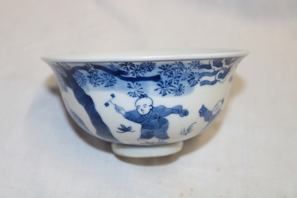 A 19th century Chinese circular bowl with blue and white figure decoration, signed,