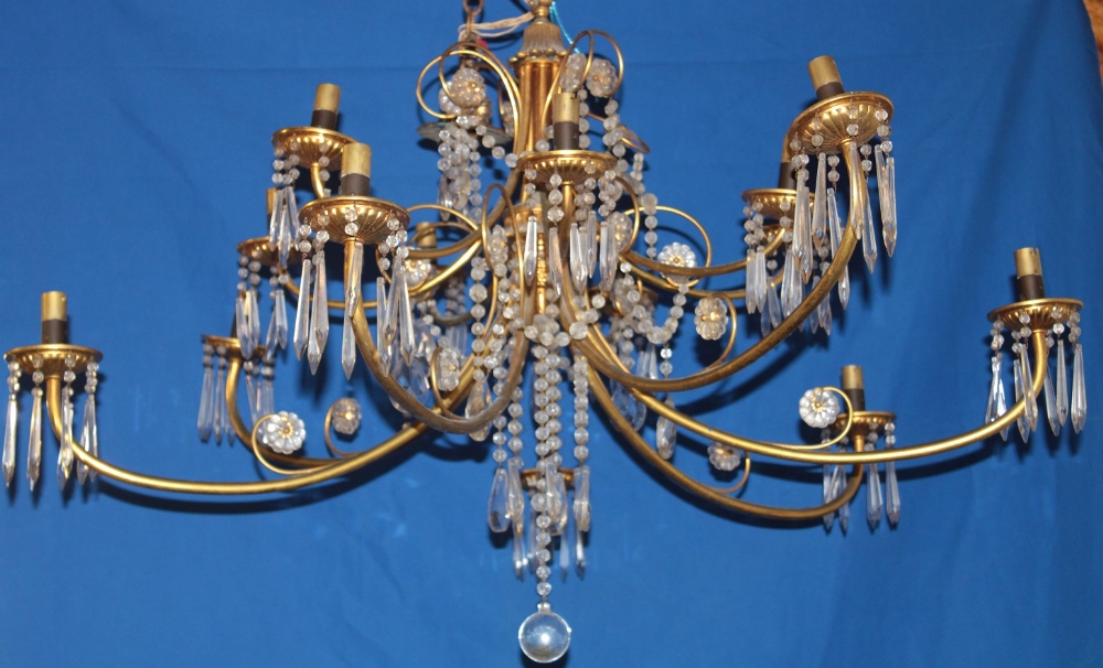 A good quality brass fourteen branch ceiling chandelier with glass lozenge droplet decoration,