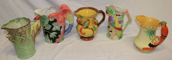 Five various pottery bird decorated jugs including Royal Falcon ware woodpecker jug,