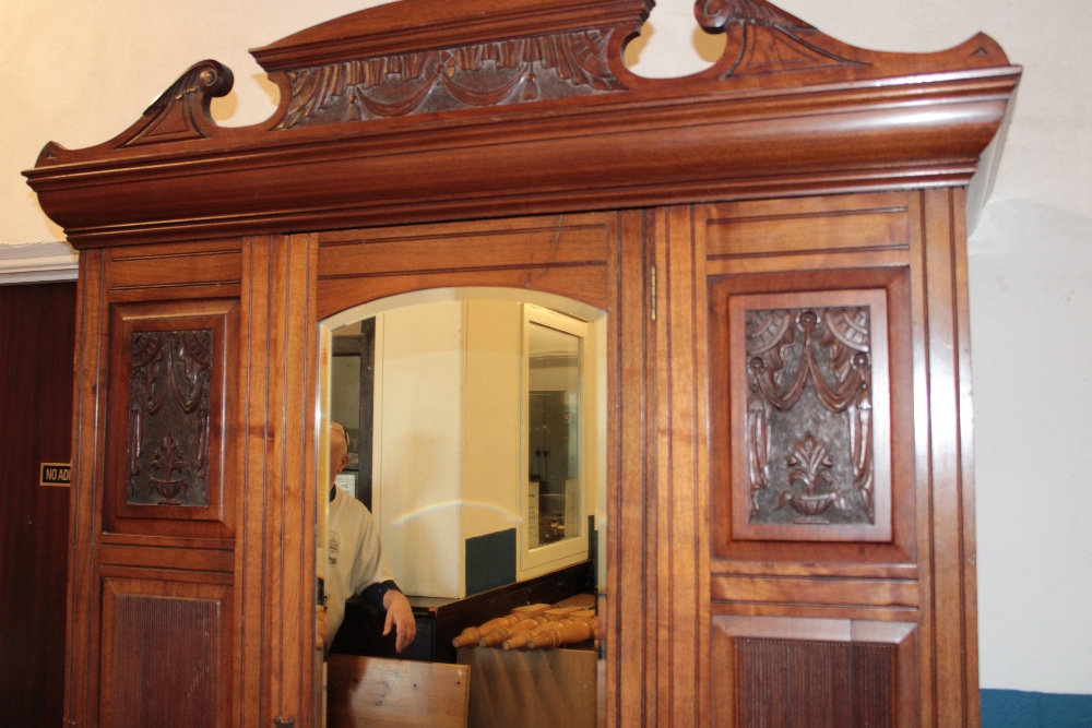 A Victorian walnut wardrobe with hanging compartment enclosed by a central mirror panel door above - Image 2 of 3