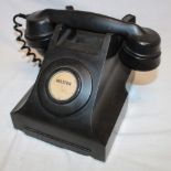 A vintage bakelite telephone marked "Helston"