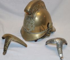 A brass Merryweather pattern fireman's helmet with crossed axes and flaming torch helmet plate,