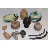 A carved coconut container and cover from Jamaica, two painted nuts from Belize,