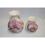 A Moorcroft pottery tapered vase with floral decoration on white ground,