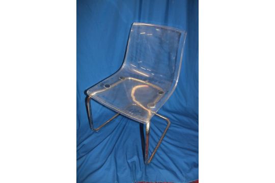 A pair of modern clear plastic "Tobias Design" chairs with chromium plated frames