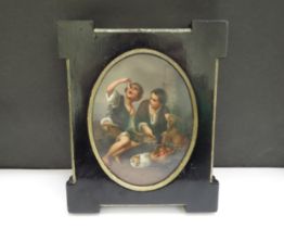 A 19th Century Continental porcelain oval panel painted with scene of two young boys with dog and