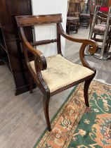 Circa 1820 a mahogany armchair with carved rope twist central bar back rest, the reeded scroll