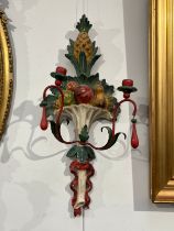 A pair of painted wool and metal wall hanging candle sconces of pineapple and fruit design, 71.5cm