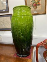 An oversized Bretby floor vase, green glaze with foliate design, 61.5cm tall