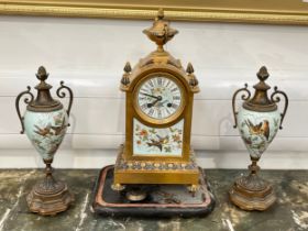 A Waterhouse & Co brass and enamel French clock garniture with bird detail, back open, 37cm x 18cm