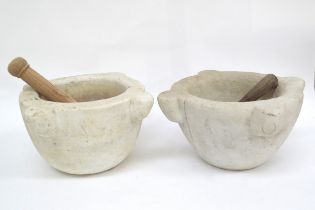 Two large marble mortars with wooden pestles one with cracks to side approximately 30cm in diameter