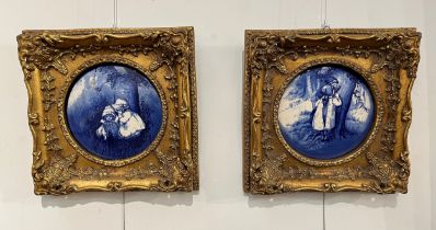 Two gilt framed blue and white pictorial porcelain plaques of circular form, 17cm diameter