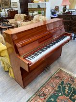 A Furstein upright piano, 106cm x 139cm X 51cm