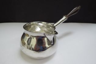 A George II silver brandy warmer of squat form, turned wooden handle, engraved with a crest for