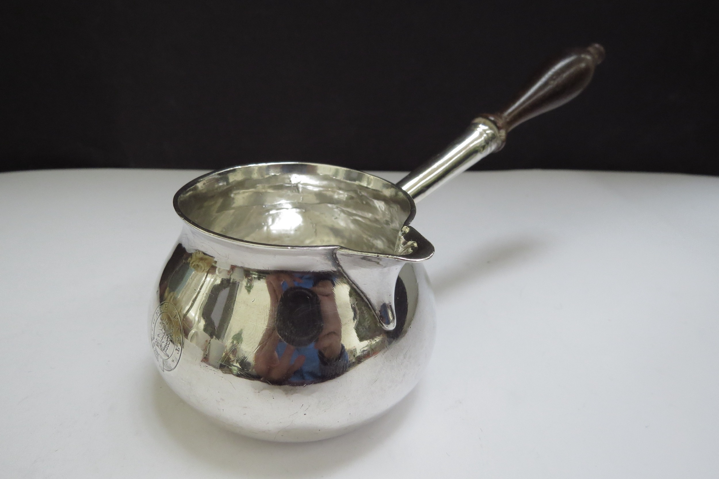 A George II silver brandy warmer of squat form, turned wooden handle, engraved with a crest for - Image 2 of 4