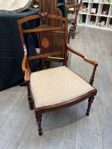 An Edwardian rosewood nursing chair, the pierced back support with central marquetry panel, on