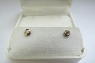 A pair of 14ct gold diamond stud earrings, 1g