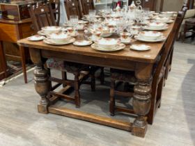 A Jacobean style country oak refectory dining table, the plank top over turned cup and cover