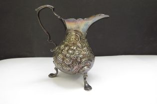 A Thomas Smith silver creamer, floral and foliate scrolled relief, raised on pad feet, London