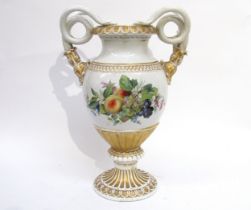 An early to mid 20th century porcelain urn, the twin serpent handles with gilt embellishment, floral