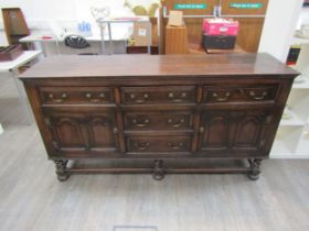 Muirhead Moffat & Co Glasgow Georgian style oak sideboard with central drawers flanked by cupboards,