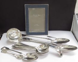 Various plated flatware including large serving ladle, serving spoons, soup spoons, and an Addison