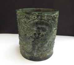 A Chinese jade brush pot decorated with a Ho-Ho bird and mythical dragon, impressed seal mark to