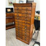 An early 20th Century oak filing cabinet set with 24 drawers, each dropping down, plinth base, 156.