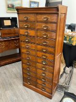 An early 20th Century oak filing cabinet set with 24 drawers, each dropping down, plinth base, 156.