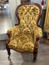 A Victorian spoon-back armchair with damask upholstery, edging loose