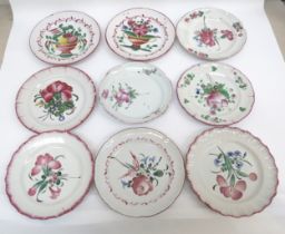 Nine 19th Century French Faience plates decorated with flowers and vases, two staple repaired