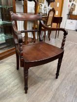 Circa 1830 an East Anglian mahogany and fruitwood armchair with carved rope twist ring turned back