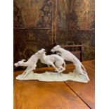 A figural group of greyhounds by Hutschenreuther, 23.5cm x 49cm long
