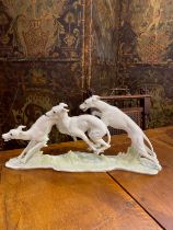 A figural group of greyhounds by Hutschenreuther, 23.5cm x 49cm long