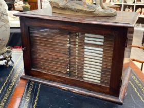 A late 19th Century mahogany microscope slide cabinet of 21 drawers with glass door. The first 11