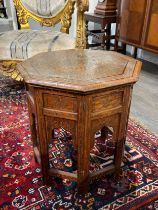 An Eastern brass inlaid octagonal table with folding base, 48cm tall the top 45cm across