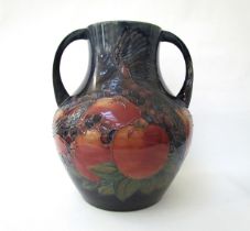 A Moorcroft Finch and Berries on blue large twin handled vase, 34cm tall