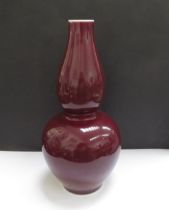 A Chinese Sang de Boeuff double gourd shaped vase with six character mark to base, 26.5cm tall