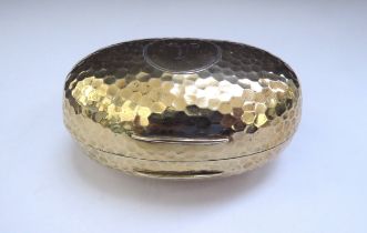 An Albert Barker Ltd silver gilt hinged ovoid shaped box with hammered decoration, circular
