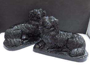 A pair of pottery 19th Chinese recumbant dogs, 15cm tall