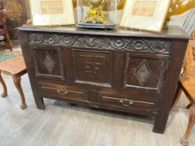 Monogrammed EF a Georgian oak mule chest with two drawers decorative floral frieze with elements
