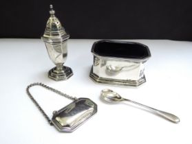 A silver salt with blue glass liner, salt spoon, Gin decanter label and pepperette, various makers
