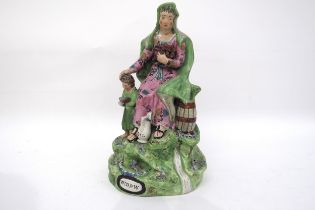 A 19th Century Staffordshire Walton figural group "Widow". Female seated holding firewood, child