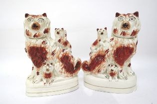 A pair of Victorian Staffordshire long haired King Charles spaniels and puppies, firing cracks