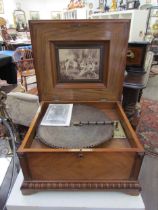 A 19th Century walnut cased table Polyphon, marquetry inlaid top, with approximately 25 15.5'' discs