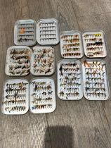 Five fly tins containing flies for trout, including feather