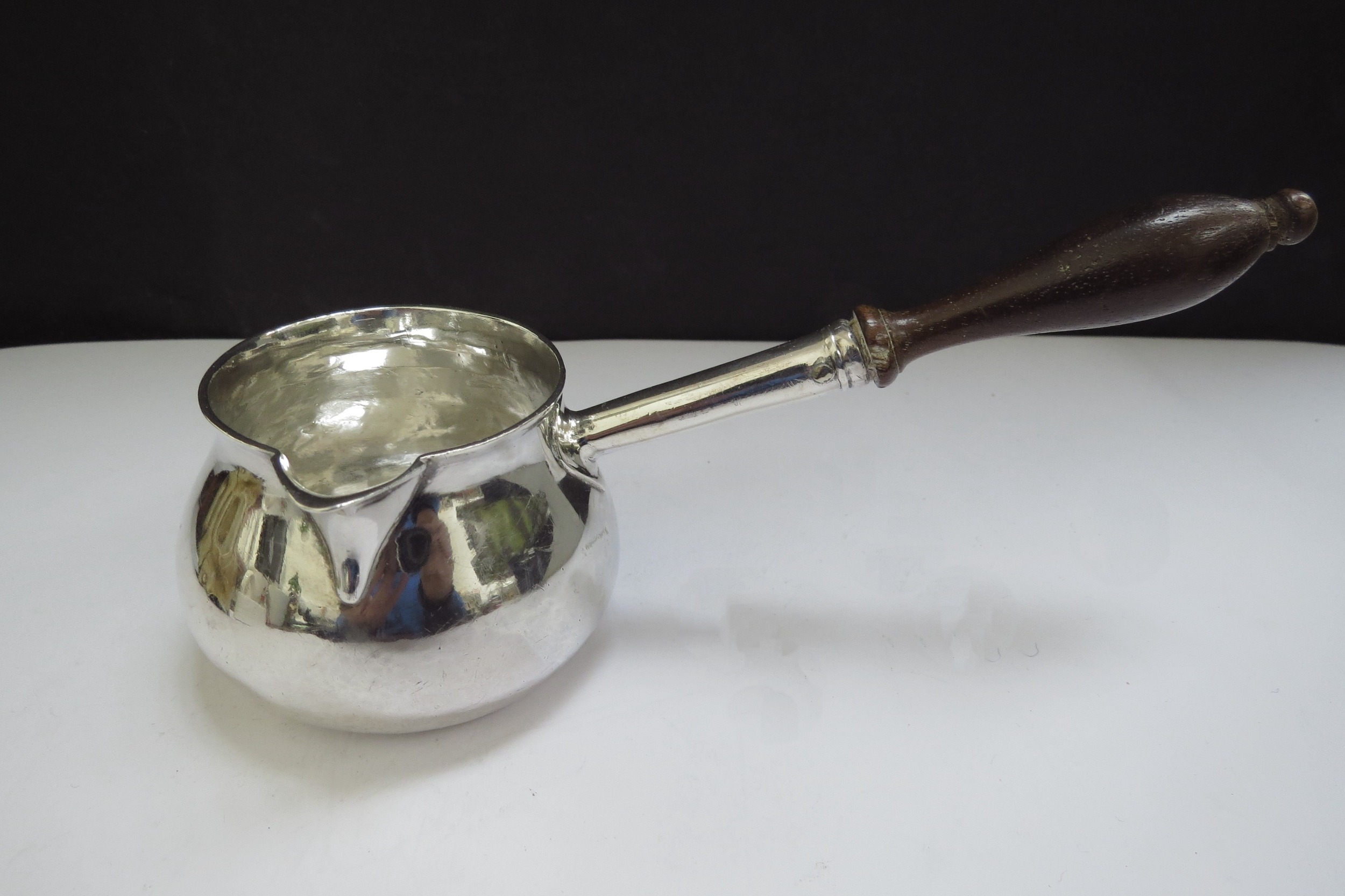 A George II silver brandy warmer of squat form, turned wooden handle, engraved with a crest for - Image 3 of 4