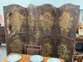 A highly decorative late 19th century leather four-fold room screen, each panel hand gilded (