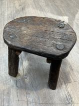 A small 17th/18th Century primitive oak stool, 25cm x 30cm x 21.5cm